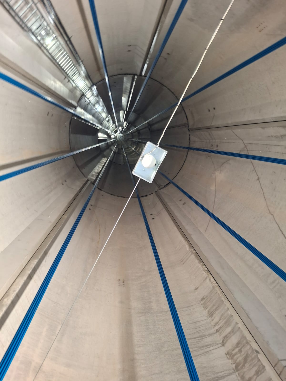 Interior of a wind turbine tower, looking up the cable runs